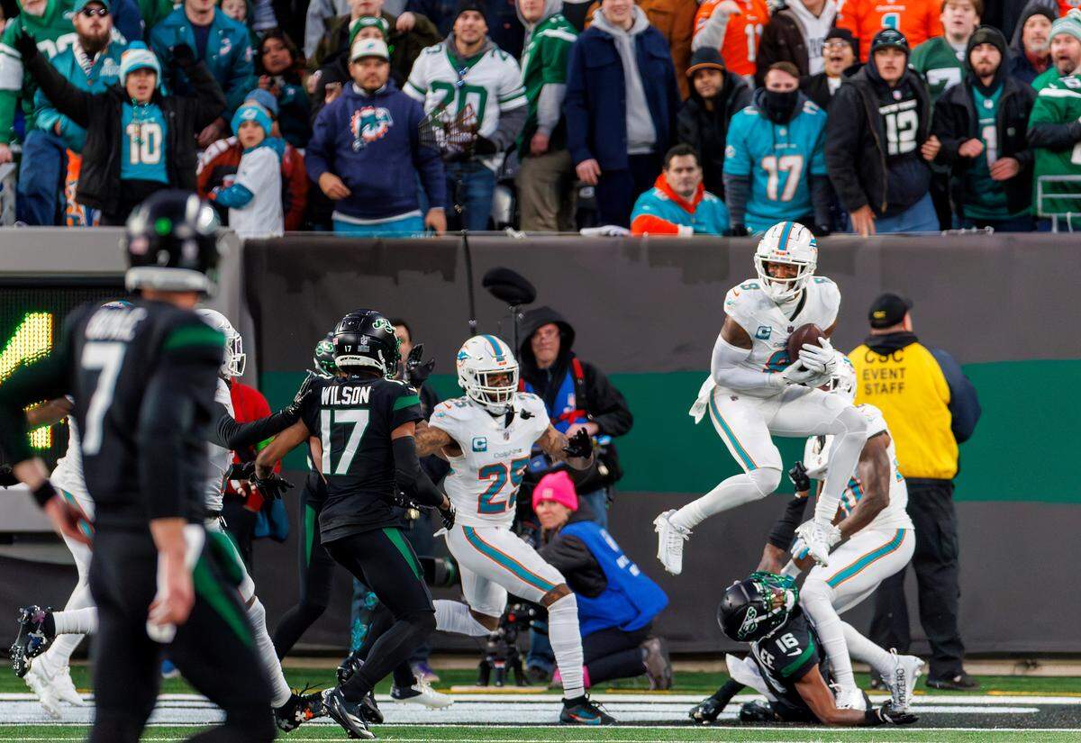 Miami Dolphins safety Jevon Holland (8) intercepted a pass by New York Jets quarterback Tim Boyle (7) during second quarter of an NFL football game at MetLife Stadium on Friday, Nov. 24, 2023 in East Rutherford, New Jersey.
