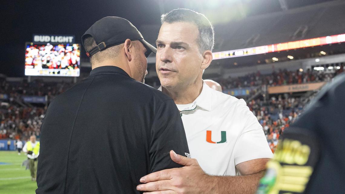 Miami Hurricanes head coach Mario Cristobal shakes hands with Iowa State Cyclones head coach Matt Campbell after their Pop-Tarts Bowl football game at the Camping World Stadium on Saturday, Dec. 28, 2024, in Orlando, Fla.