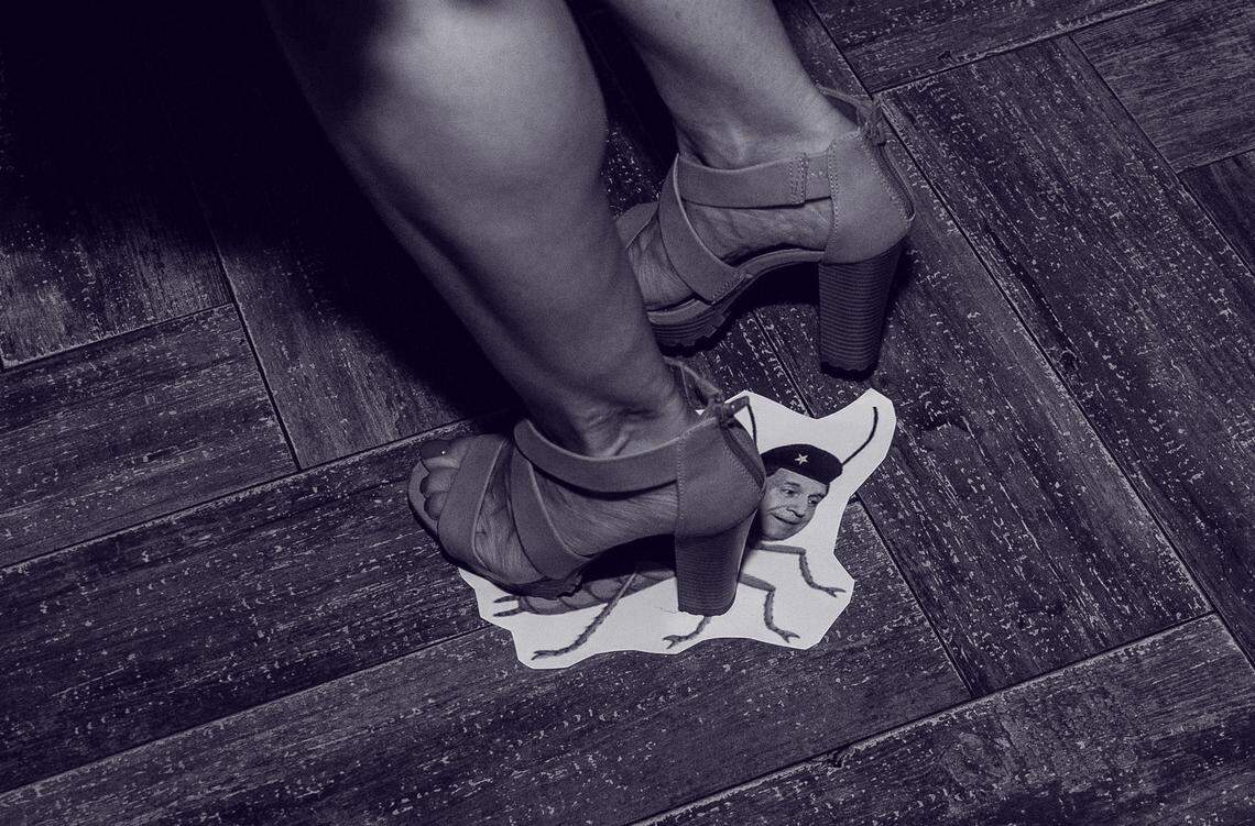 Celebrating Ball & Chain’s court victory, a dancer steps on the image of a cockroach, with the head substituted with that of Joe Carollo.