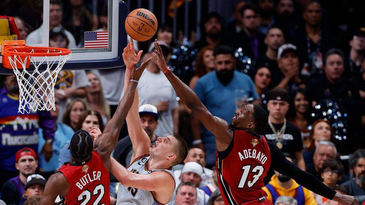 Jun 12, 2023; Denver, Colorado, USA; Denver Nuggets center Nikola Jokic (15) battles for a rebound against Miami Heat forward Jimmy Butler (22) and center Bam Adebayo (13) during the third quarter of game five of the 2023 NBA Finals at Ball Arena. Mandatory Credit: Isaiah J. Downing-USA TODAY Sports