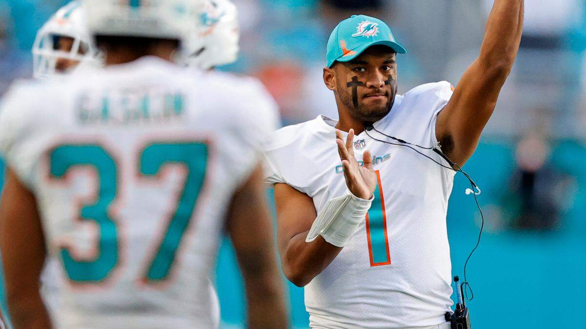 Miami Dolphins quarterback Tua Tagovailoa (1) and running back Myles Gaskin (37) during second quarter of an NFL football game against the Houston Texans at Hard Rock Stadium on Sunday, November 7, 2021 in Miami Gardens, Florida.