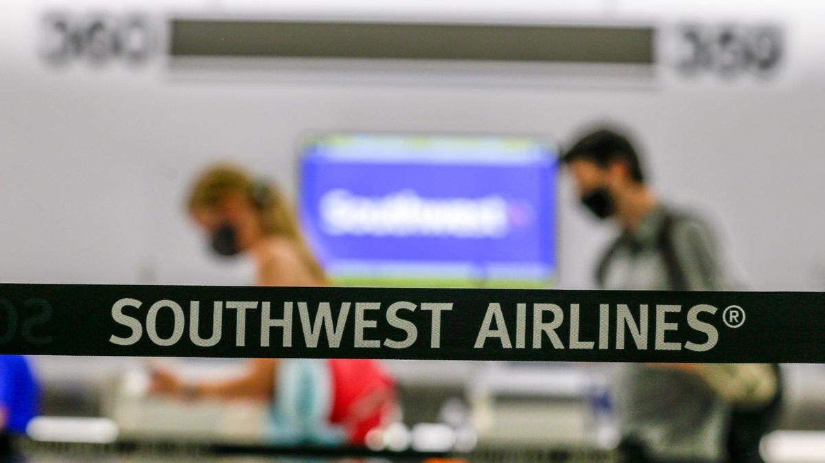Travelers flying with Southwest Airlines check in before their flight inside Concourse G at Miami International Airport on Friday, August 6, 2021.