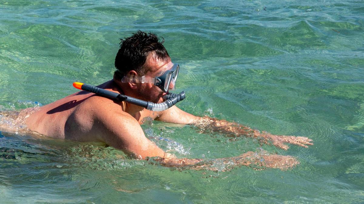 A man snorkels around the jetty at Bill Baggs Cape Florida State Park in Key Biscayne, Florida, on Wednesday, Feb. 22, 2023. February ended on a hot streak. March kept it going, along with a dry patch.