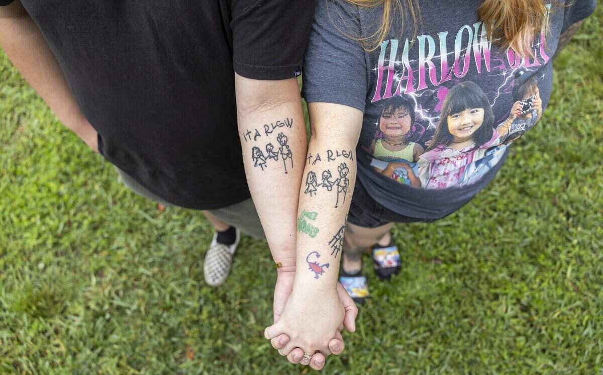 Danny Tran and his wife, Samari Curbelo, display matching tattoos based on a drawing made by their daughter, Harlow Jet Tran, 6, in the backyard of their home on Wednesday, June 3, 2026, in Coral Springs, Fla. Harlow was killed in a car accident, after a man fleeing a Coral Springs officer on May 5, 2024, struck the SUV driven by her great-grandmother. The family has filed a wrongful-death lawsuit against the city.