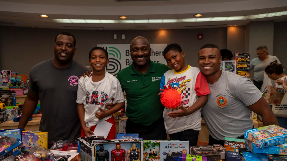 Left to right: BBBSM Big and Miami-Dade Fire Rescue Firefighter/Paramedic Christopher Griffin, BBBSM Little, Gale Nelson, BBBSM Little, and BBBSM Big and Miami-Dade Fire Rescue Firefighter/EMT Darious Avant pose together during the BBBSM 2024 Holiday Party. Photo credit: World Red Eye.