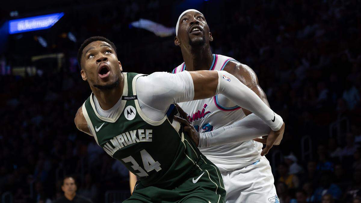 Milwaukee Bucks forward Giannis Antetokounmpo (34) and Miami Heat center Bam Adebayo (13) battle for position under the basket during the first half of their game at Kaseya Center in Miami on April 5, 2025.