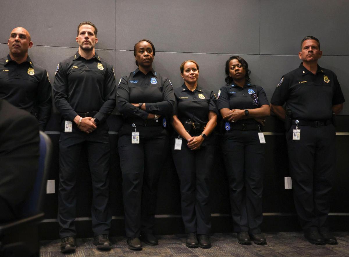 Chief of Police Edwin Lopez, second from the left, stands with members of his staff in the back of a city council meeting on Wednesday, April 16, 2025.