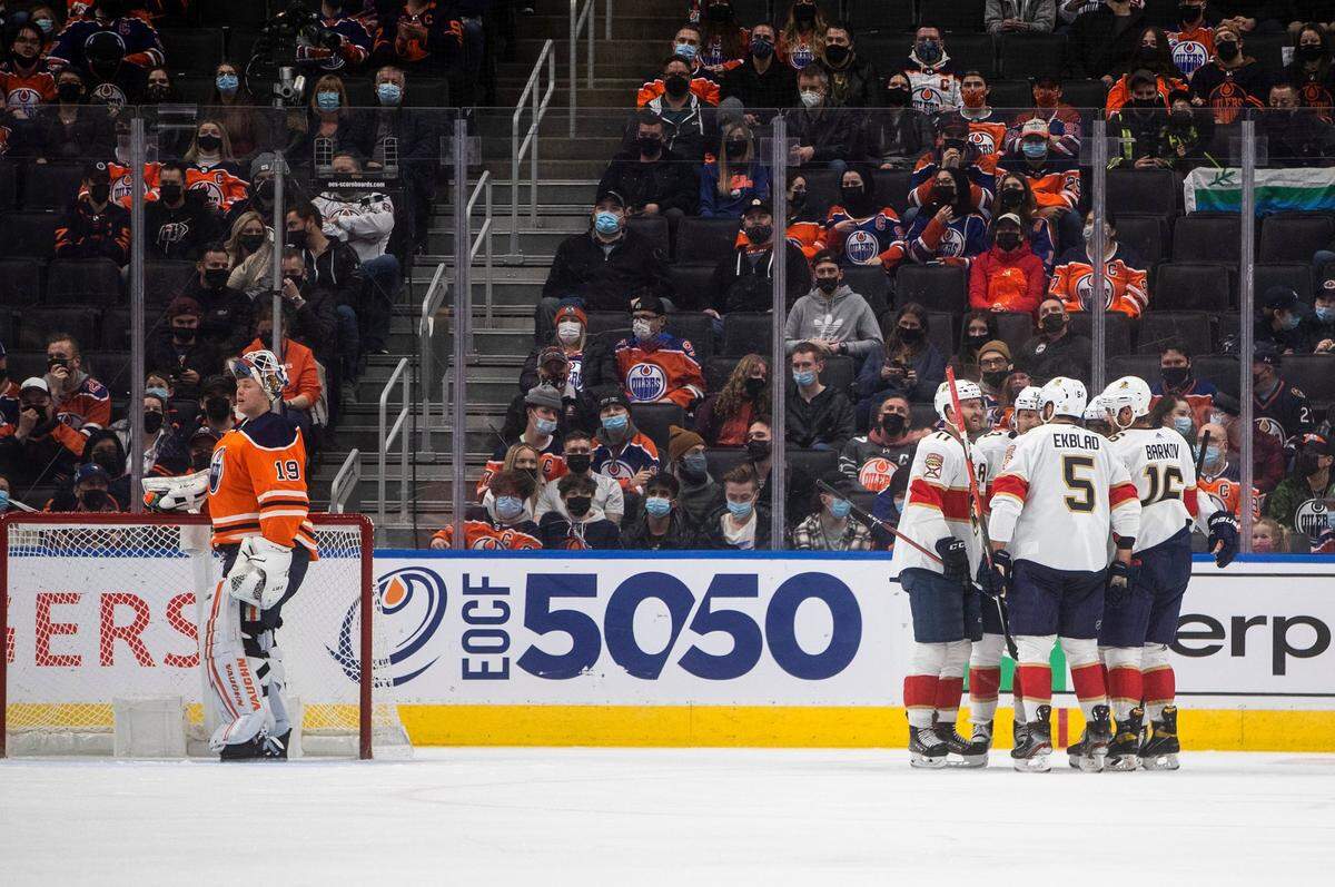 Florida Panthers players celebrate a goal on Edmonton Oilers goalie Mikko Koskinen (19), left, during the second period of an NHL hockey game Thursday, Jan. 20, 2022, in Edmonton, Alberta. (Jason Franson/The Canadian Press via AP)