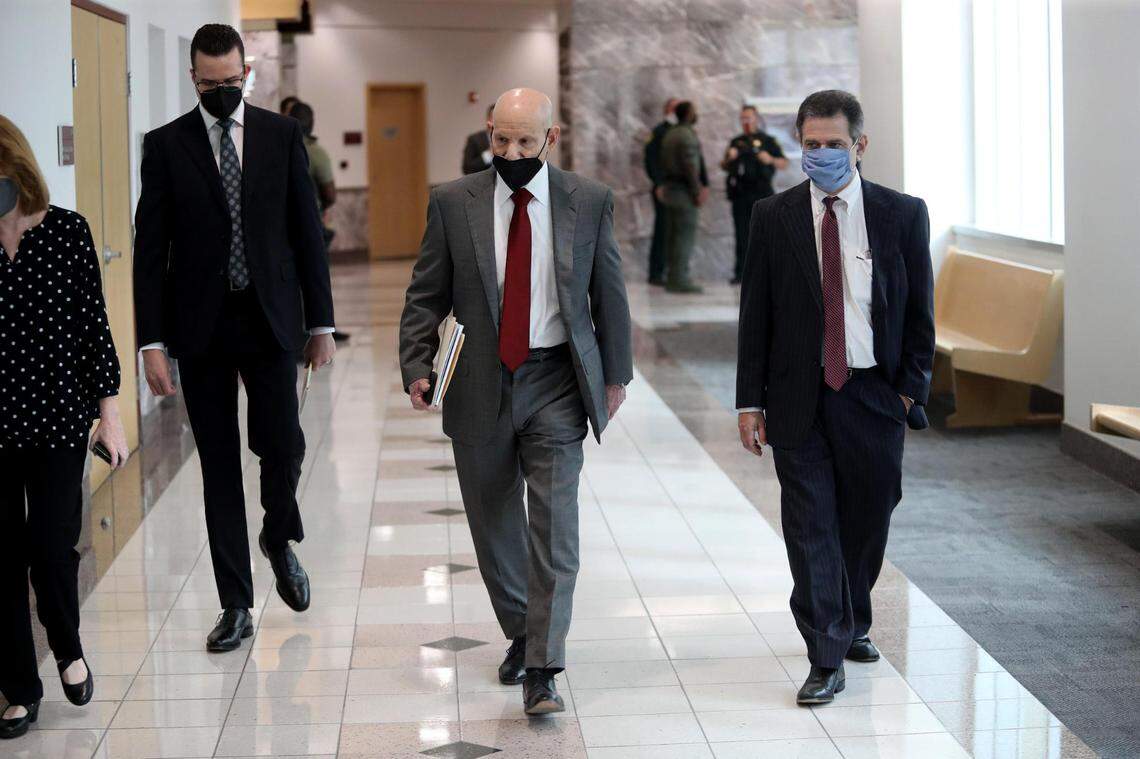 Broward County State Attorney Mike Satz, center, walks into the courtroom during a hearing last year..