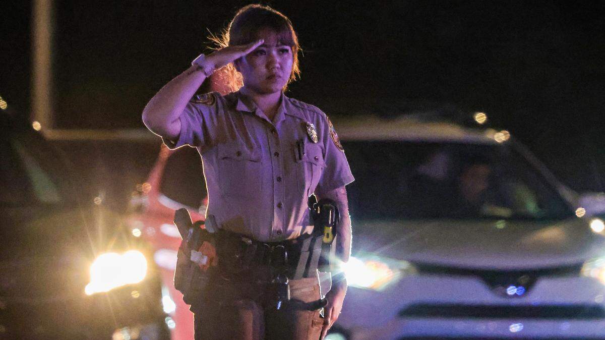 Police officers saluted the procession carrying the body of Miami-Dade Deputy Devin Jaramillo. He responded to a traffic accident and was shot to death on Nov. 7, 2025.