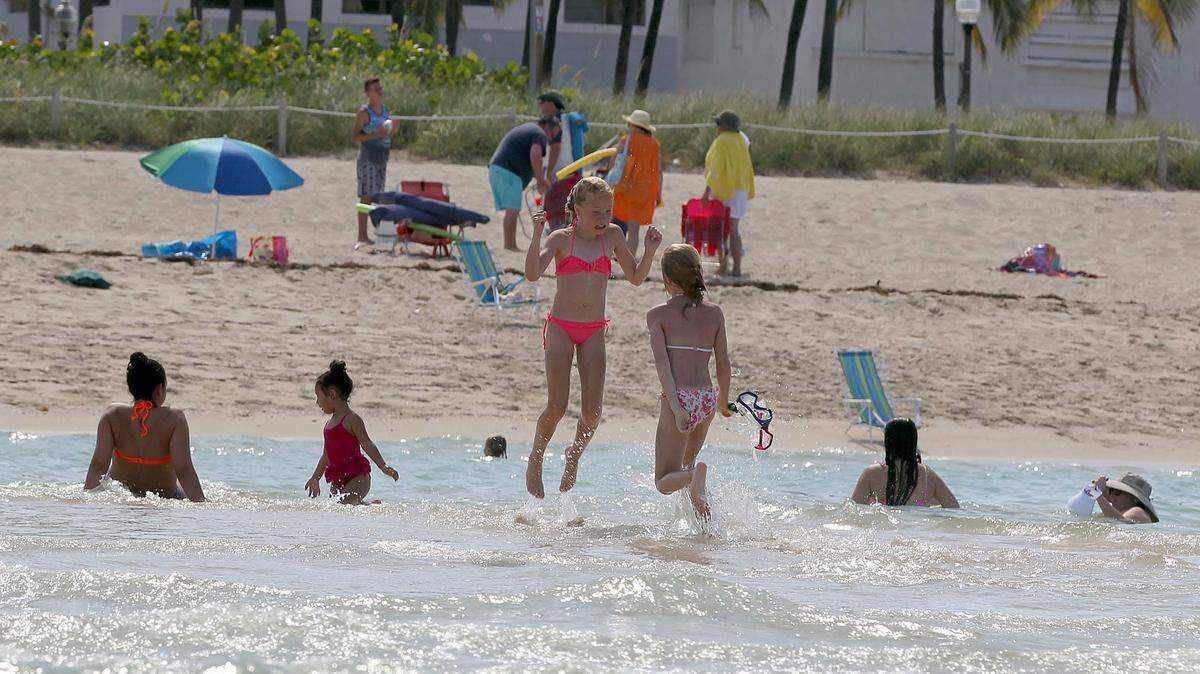 People spend time on a sand bar in Miami Beach to stay cool as the National Weather Service issued a heat advisory for the first time in seven years for South Florida Tuesday with heat indexes expected to reach 110 degrees, on Tuesday July 05, 2016.
