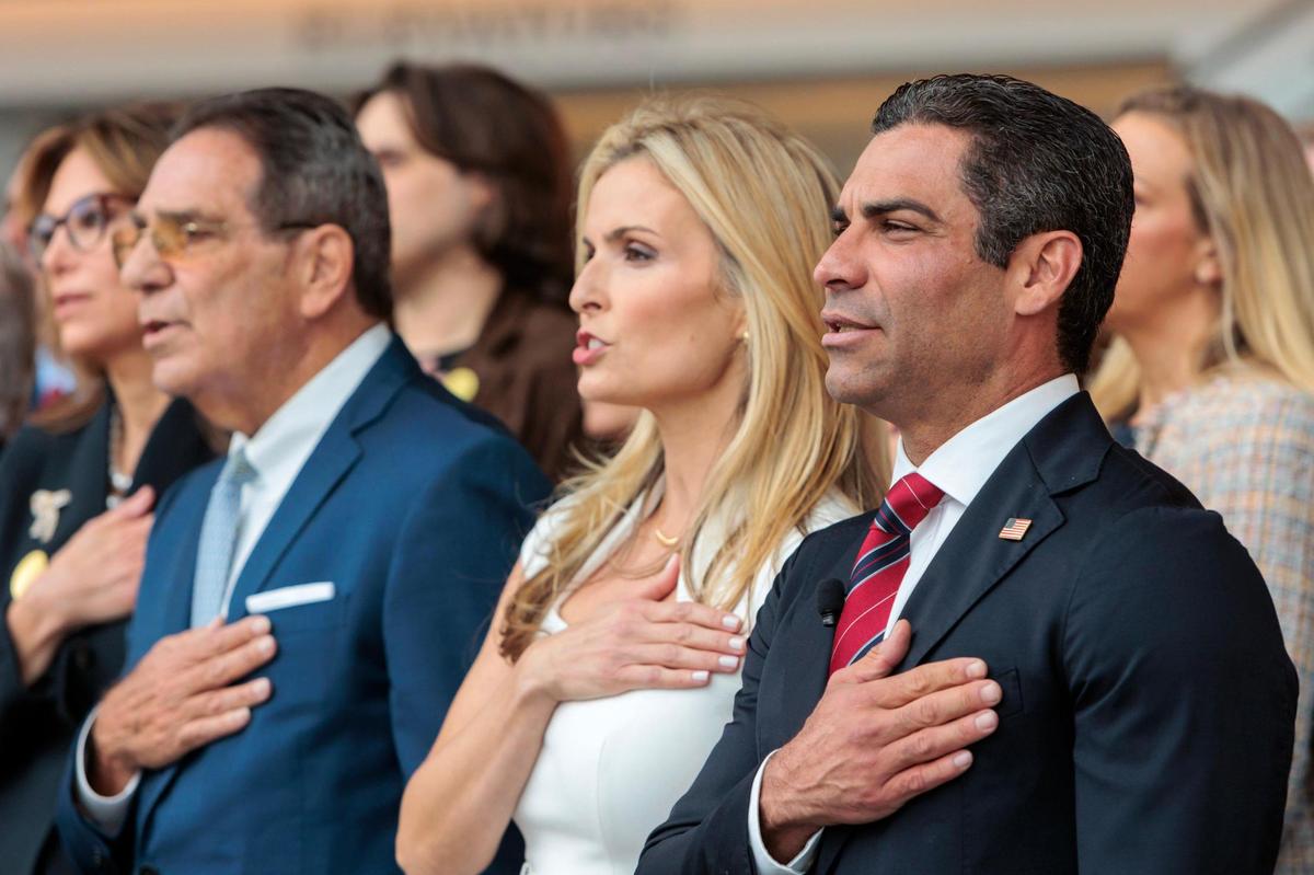 Miami Mayor Francis Suarez, right, wife Gloria and father former Miami Mayor Xavier Suarez recite the Pledge of Allegiance before Francis Suarez’s first speech as a candidate for the 2024 Republican presidential nomination at the Ronald Reagan Presidential Library in Simi Valley, California, on Thursday, June 15, 2023.