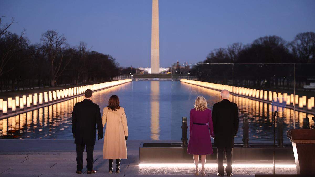 On Jan. 19, Douglas Emhoff, U.S. Vice President-elect Kamala Harris, Dr. Jill Biden and U.S. President-elect Joe Biden stand at the Lincoln Memorial Reflecting Pool on the National Mall as lamps are lit to honor the more than 400,000 U.S. victims of the coronavirus pandemic.