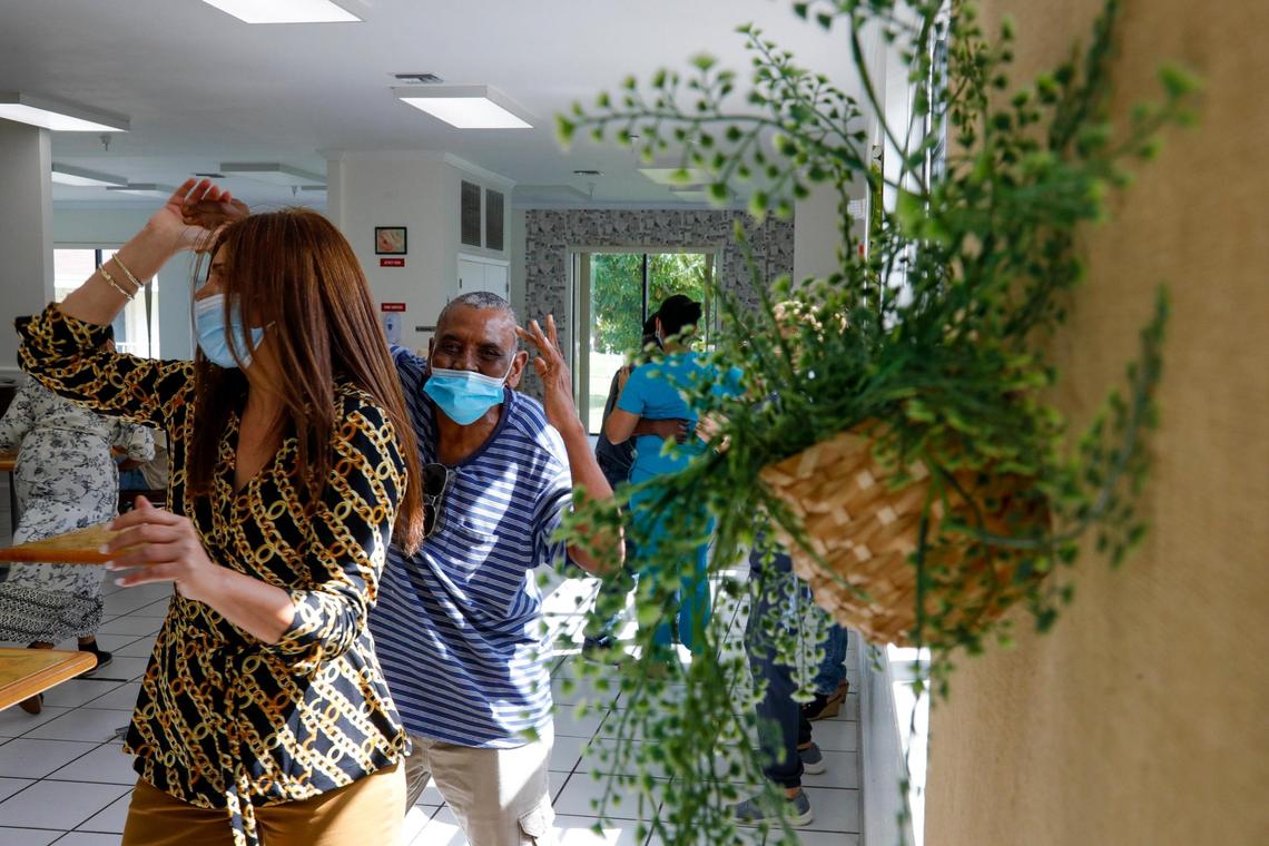 Guillermo Torres, 77, dances with Casa Mia program director Roxana Solano as live salsa music plays in the cafeteria at Mia Casa, the former assisted living center in North Miami that the Homeless Trust is renting out to house Miami’s growing homeless senior population. The Trust wants to isolate the seniors to reduce the risk of contracting COVID-19 from others in homeless shelters.