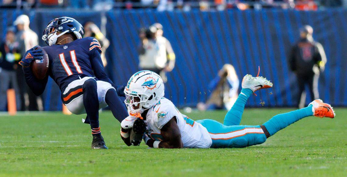 Miami Dolphins cornerback Kader Kohou (28) tackles Chicago Bears wide receiver Darnell Mooney (11) during fourth quarter of an NFL football game at Soldier Field on Sunday, November 6, 2022 in Chicago, Illinois.