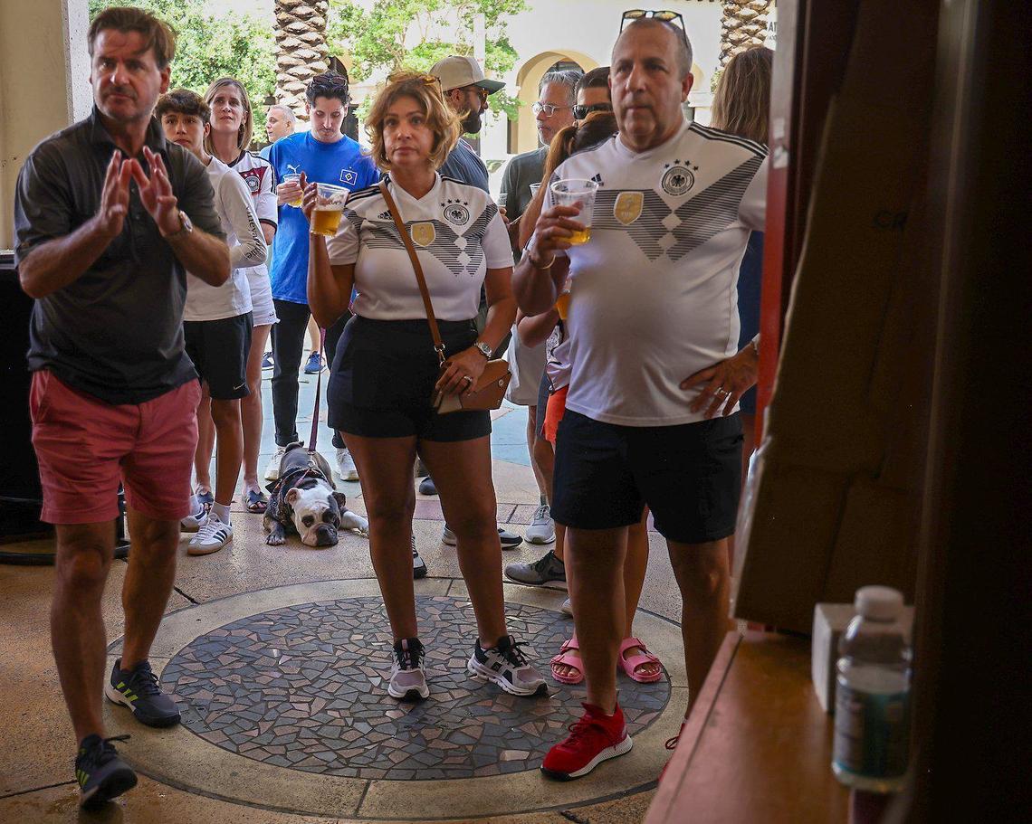 Fans watch the soccer match between Germany and Switzerland at the front door of Fritz & Franz Bierhaus.