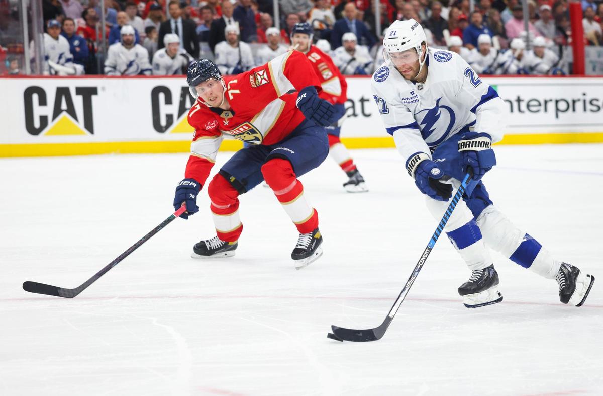 Tampa Bay Lightning center Brayden Point (21) takes the puck down the ice passed Florida Panthers defenseman Niko Mikkola (77) during the second period of Game 4 of the first-round Stanley Cup playoff series on Monday, April 28, 2025, at Amerant Bank Arena in Sunrise, Fla.