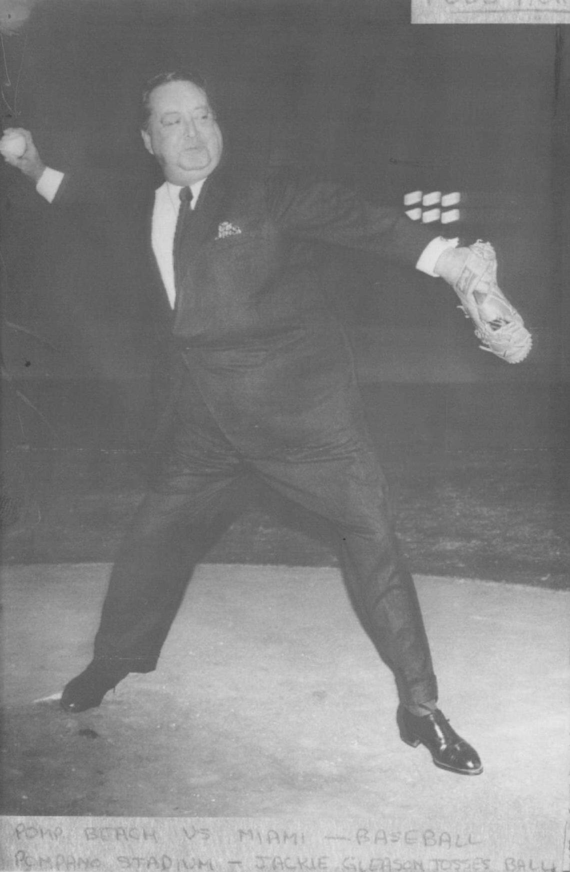 Jackie Gleason winds up and tosses a ball at a stadium in Pompano Beach in 1972.