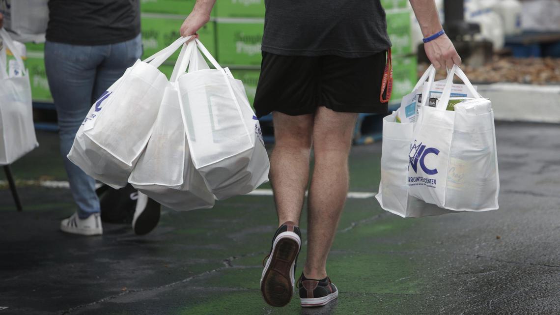 Miami, Florida, September 10, 2020- A volunteer delivers bags of food to a distribution station at the Greater Miami Jewish Federation during a Kosher Food Distribution Drive-Thru Event . While the drive-thru is open to all in need, it is a unique opportunity for members of the Jewish community who follow strict kosher dietary laws to receive items like Kosher ground meat, frozen meals, as well as locally grown fruits and vegetables.