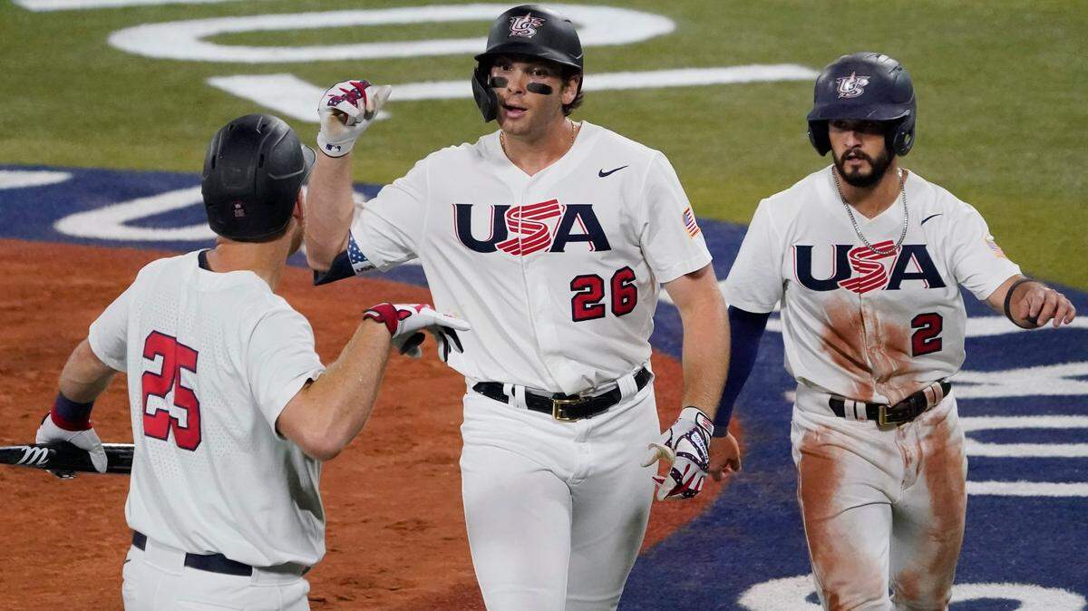United States’ Triston Casas (26) celebrate with Todd Frazier, left, and Eddy Alvarez right afterhitting a two run home run during the fourth inning of a baseball game against South Korea at the 2020 Summer Olympics, Saturday, July 31, 2021, in Yokohama, Japan. (AP Photo/Sue Ogrocki)