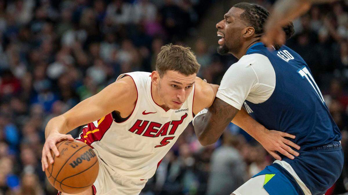 Miami Heat forward Nikola Jovic (5) drives to the basket past Minnesota Timberwolves center Naz Reid (11) in the second half at Target Center.