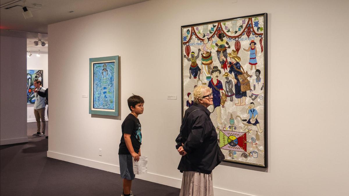 On Tuesday, June 6, 2023, art lovers browse through the recently opened Haitian art show entitled “Cosmic Mirrors” at NSU Art Museum in Fort Lauderdale, Florida.