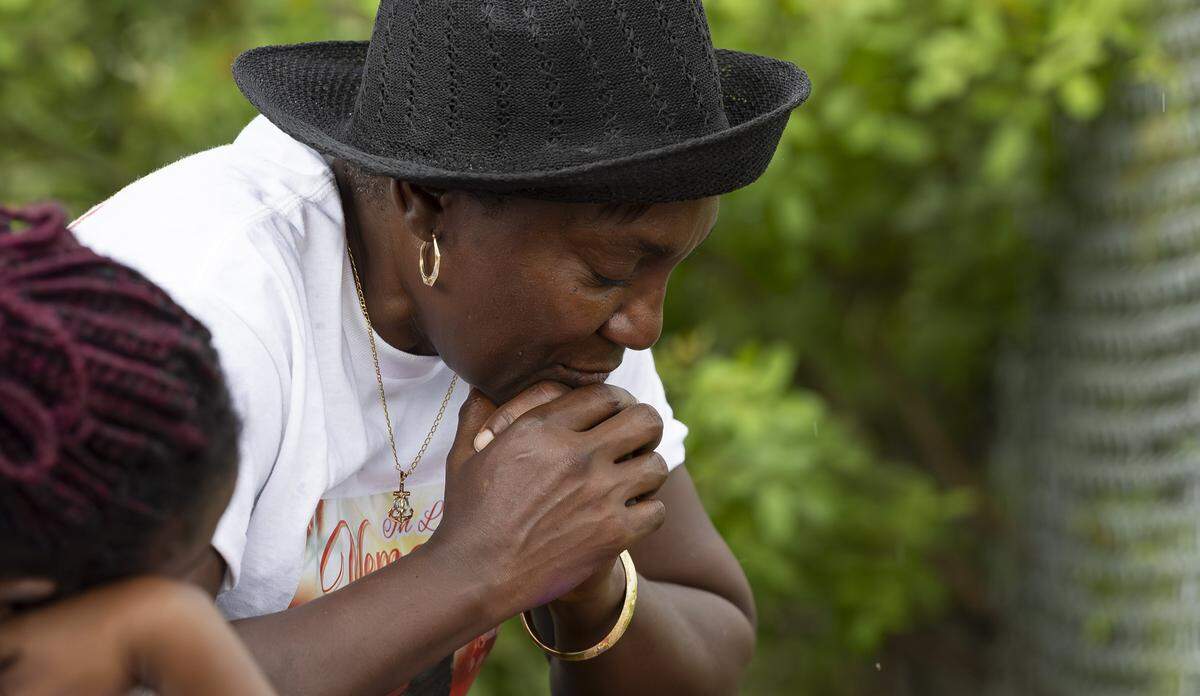 Shelley Ann Williams visits a makeshift memorial for her mother, Doreen Richards Broadbelt, 71, who police said was walking to her job at Walmart when a dog attacked and fatally mauled her near her home on Labor Day. A vigil was held nearby at Broadbelt's home on Tuesday, Sept. 9, 2025, in Miami Gardens, Fla.