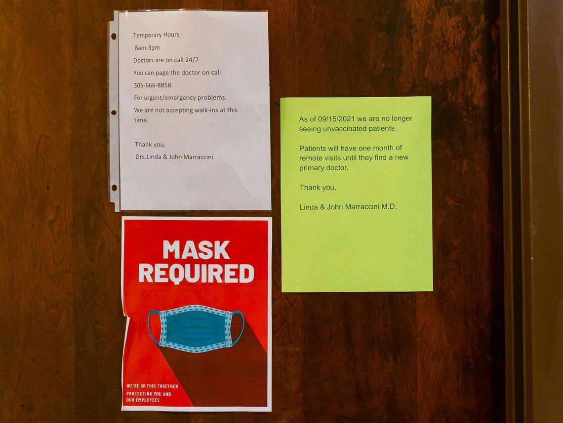 A notice on the door of Dr. Linda Marraccini’s medical office in South Miami, Florida, on Sept. 3, 2021, informs patients of a vaccine mandate. Marraccini has given her patients until Sept. 15 to either get vaccinated against COVID-19 or find a new doctor.