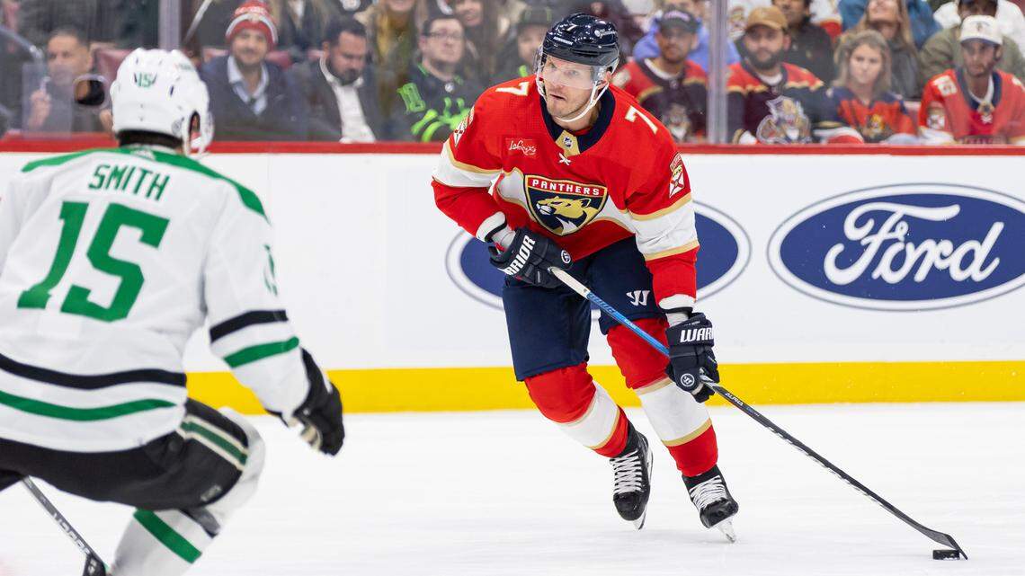 Florida Panthers defenseman Dmitry Kulikov (7) skates with the puck as Dallas Stars center Craig Smith (15) defends in the second period of their NHL game at the Amerant Bank Arena on Wednesday, Dec. 6, 2023, in Sunrise, Fla.