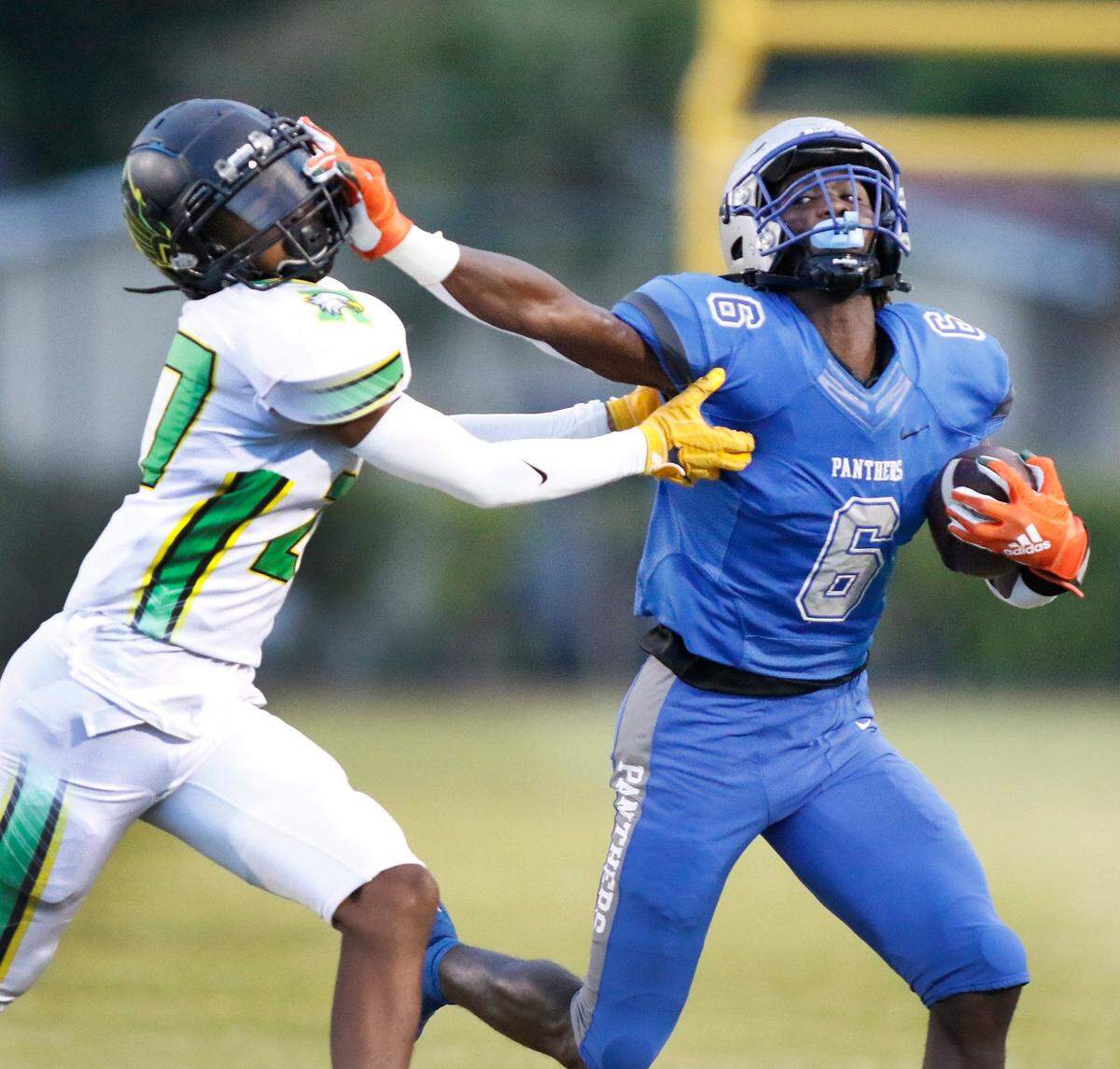 Dillard Panthers running back Christopher Johnson (6) attempts to escape Rock Creek Christian Academy’ defender during football game on Friday, August 26, 2022 at Dillard High School in Fort Lauderdale. Andrew Uloza / for Miami Herald