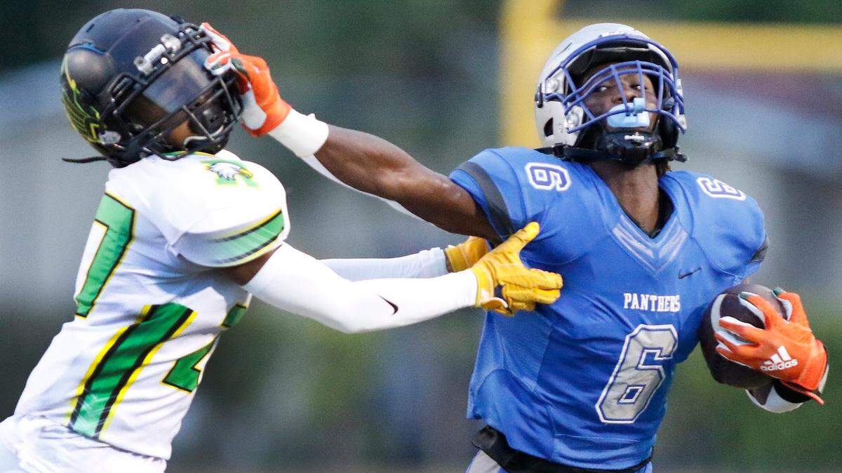 Dillard Panthers running back Christopher Johnson (6) attempts to escape Rock Creek Christian Academy’ defender during football game on Friday, August 26, 2022 at Dillard High School in Fort Lauderdale. Andrew Uloza / for Miami Herald
