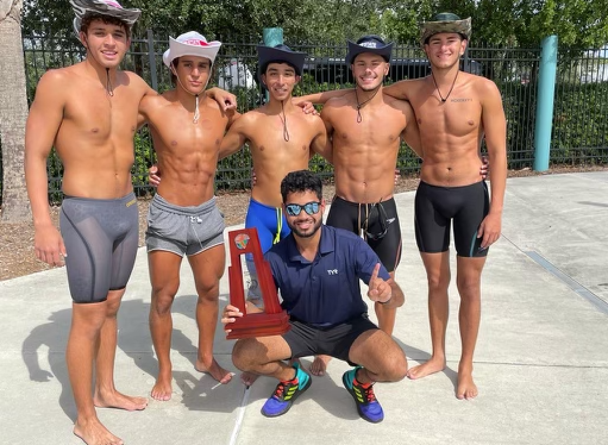 Mater Lakes Academy coach Caesar Asadi (in front) poses with swimmers Agustin Rodriguez (from left), Anthony Robaina, Ronny Rueda, Matthew Tarafa and Anthony Martinez.