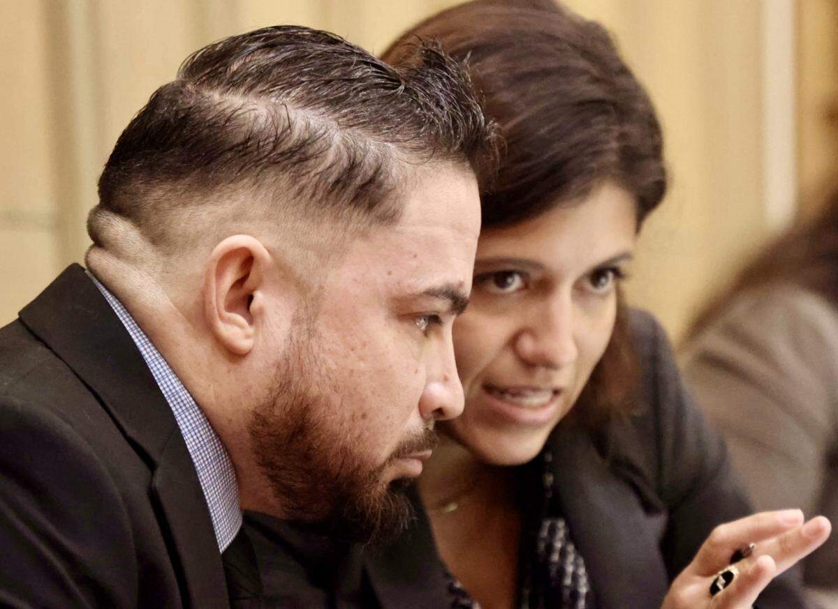 Daniel Ramos-Aviles, left, listens to defense attorney Natalie Lopez during the closing arguments of his trial, on Sept. 3, 2025, in Miami.