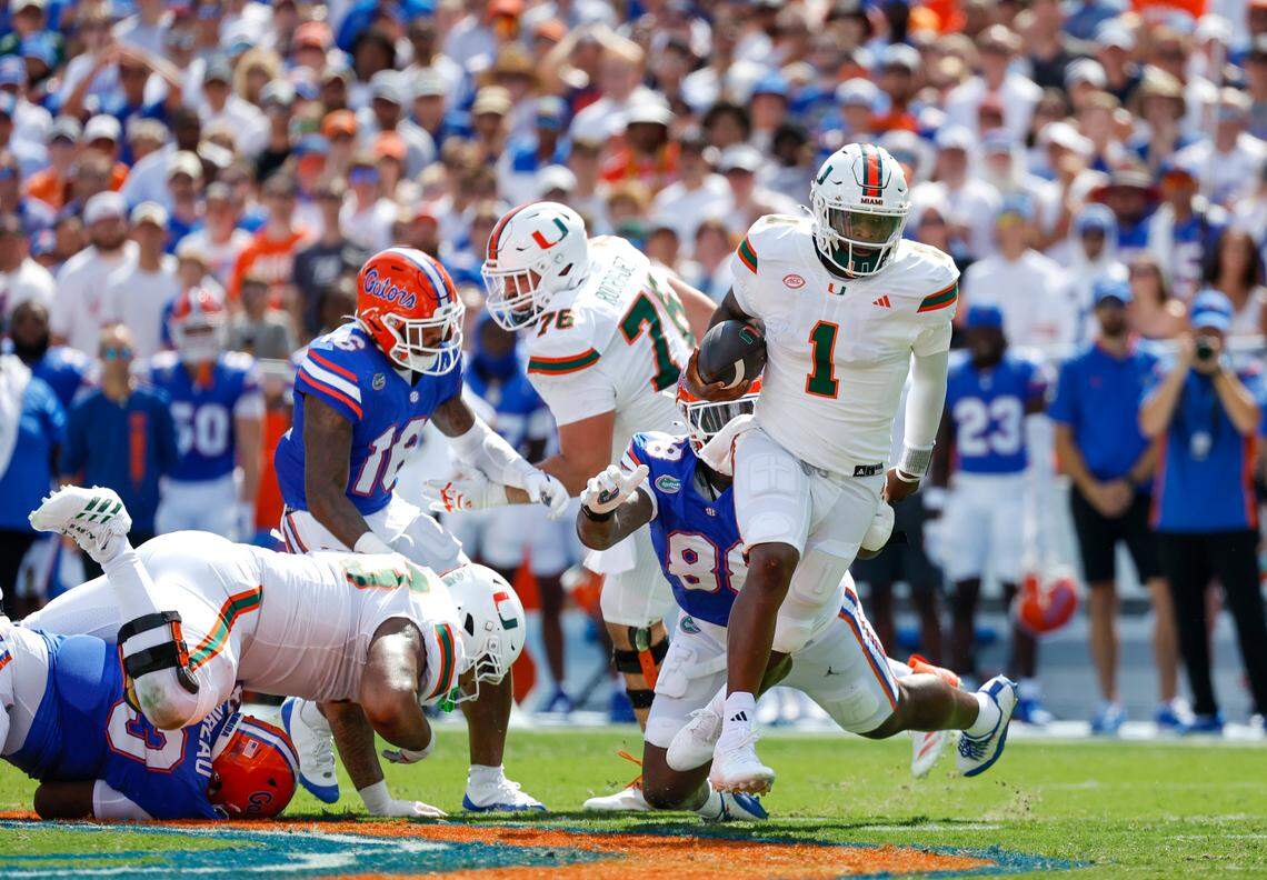 Miami Hurricanes quarterback Cam Ward (1) scrambles for yardage during the first half of an NCAA college football game against the Florida Gators at Ben Hill Griffin Stadium in Gainesville, Florida, on Saturday, August 31, 2024.