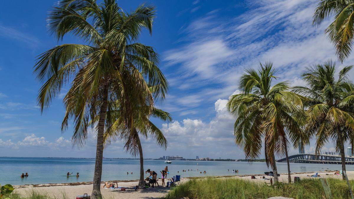 Beachgoers enjoy the nice weather at Hobie Island Beach as South Florida swelters under a heat advisory that warns of feels-like temperatures of 108, thoughts turn to the coming long Labor Day weekend in Miami , on Wednesday, August 27, 2025. 