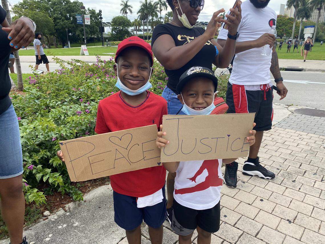 Castera Pierre, 47, brought his children to the religious protest at the Torch of Friendship in downtown Miami on June 14, 2020.