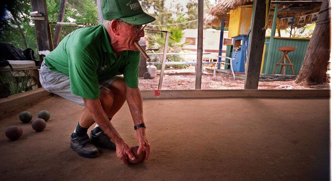 2/29/00--PHOTO BY JON KRAL--STREET--JIMBO’S ON VIRGINIA KEY-- In 2000, Jim ”Jimbo” Luznar Sr., with his trademark big cigar, shows his form with the bocce ball.