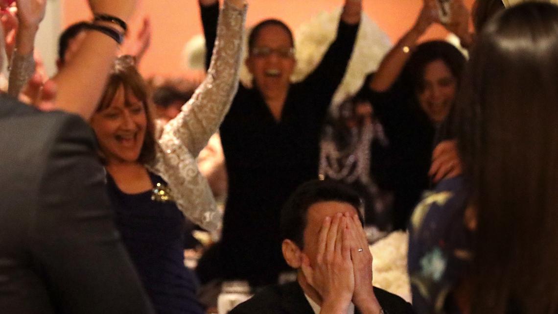 Oliver Diez, a music teacher at Palmetto Elementary, center, covers his face as colleagues, friends, and family celebrate his winning the 2020 Francisco R. Walker Miami-Dade County Teacher of the Year award on Thursday, Jan. 31, 2019.