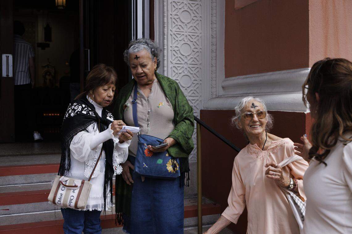 Women talk outside of the church after an Ash Wednesday mass on Wednesday, Feb. 18, 2026, at Gesu Catholic Church in downtown Miami. 