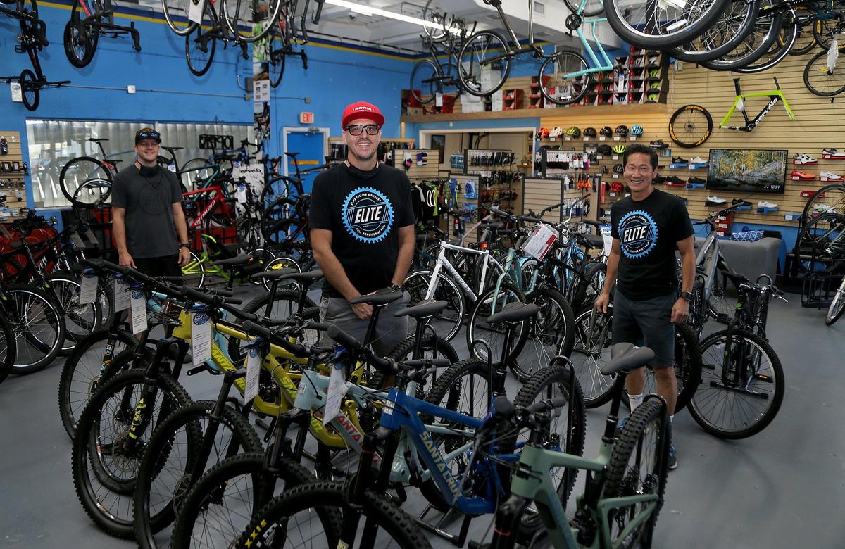 Elite Cycling owner Marcelo Penengo, center, stands in his shop with staff members Matt Walsh, left, and Glenn Chin in May, before it was allowed to reopen. Since then the shop has been thriving thanks to high demand for new bicycles and repair of old bikes amid the coronavirus pandemic.