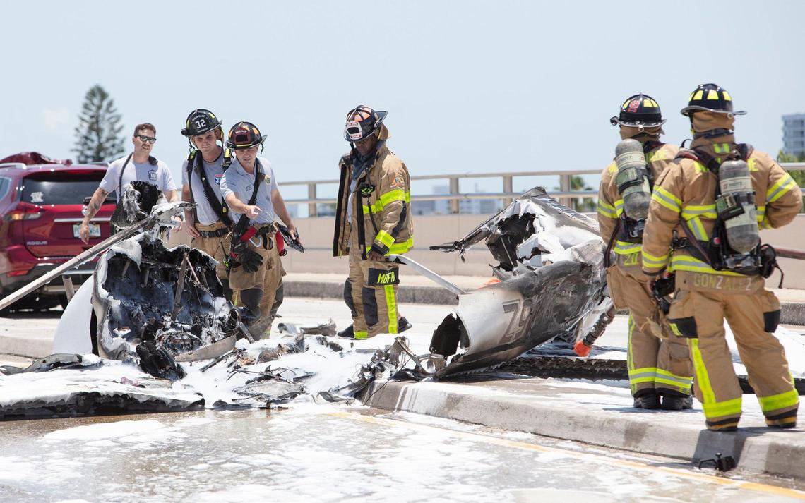 Firefighters work at the scene of a plane crash at the Haulover Bridge has sent at least one person to the hospital, Miami-Dade Fire Rescue said.