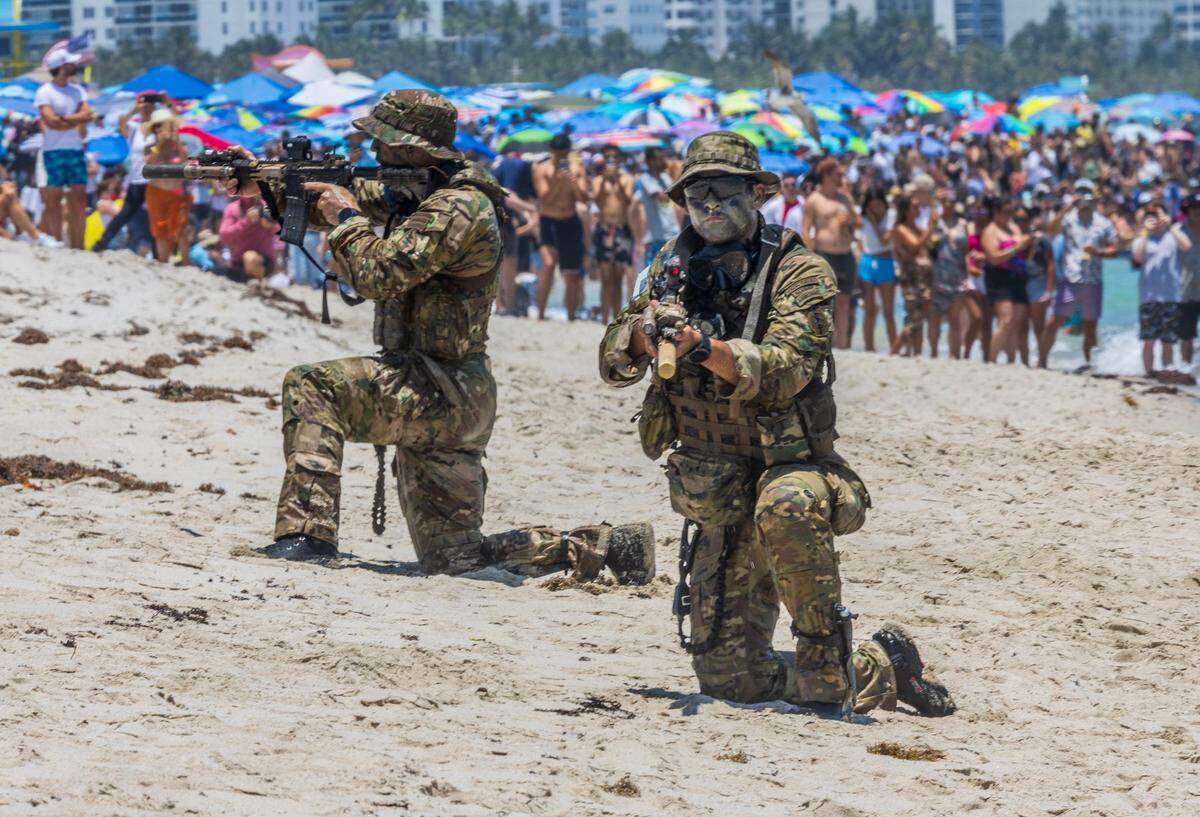 Members of the U.S. Army Special Operations Command (Airborne) disembark during a demonstration at the Hyundai Air & Sea Show in South Beach, part of the annual National Salute to America’s Heroes, on Saturday, May 24, 2025, in Miami Beach.