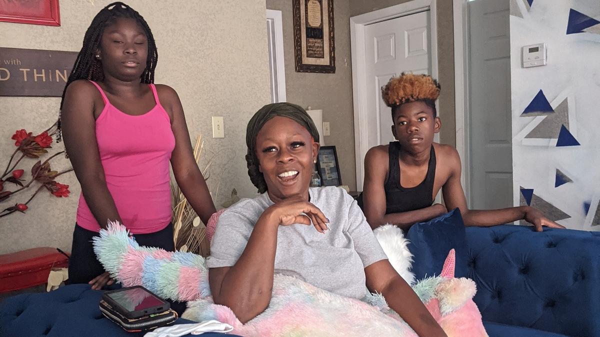 Dulcinea Harris, center, whose daughter police said was shot and killed by her husband Carl Monty Watts Jr. Sunday at a community center swimming pool, remembers her daughter. At left is her granddaughter, Simiyah Harris, 11, and at right is her son Isaiah Harris, 14.