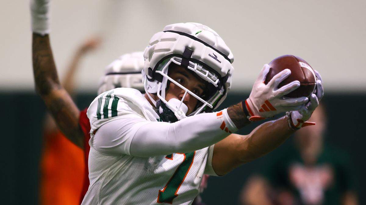 Miami Hurricanes wide receiver Xavier Restrepo (7) catches the football during training camp at the Carol Soffer Indoor Practice Facility at the University of Miami in Coral Gables, Florida, Saturday, August 3, 2024.