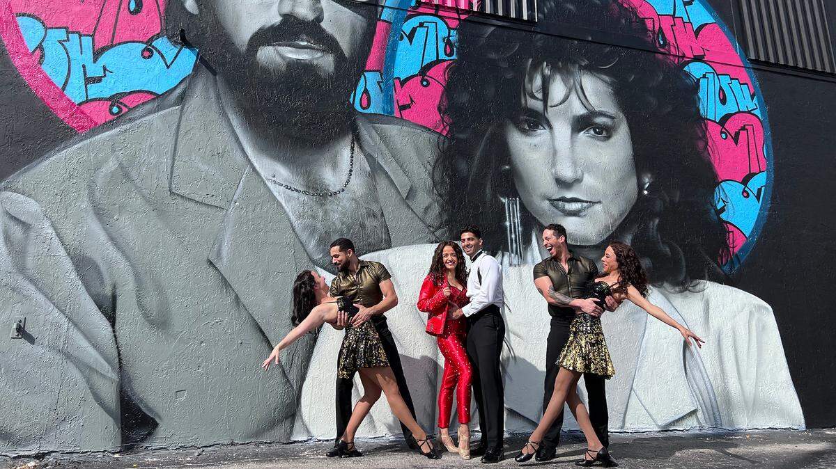 Actors’ Playhouse ‘ON YOUR FEET!’ cast members Natalie Caruncho, Hector Maisonet, Claudia Yanez, Jason Canela, Jeremey Adam Rey and Alejandra Matos pose in front of local artist Disem’s new mural of the Estefans at La Casa De Los Trucos in Little Havana.