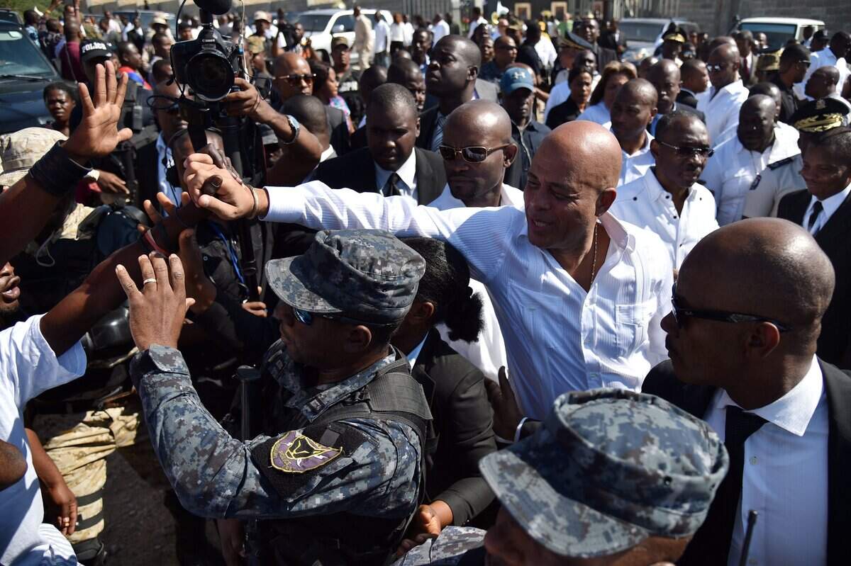 Haitian President Michel Martelly greets supporters after placing flowers during a memorial ceremony January 12, 2016 in Port-au-Prince, in honor of the victims of earthquake that hit Haiti in January 12, 2010. (HECTOR RETAMAL/AFP via Getty Images)