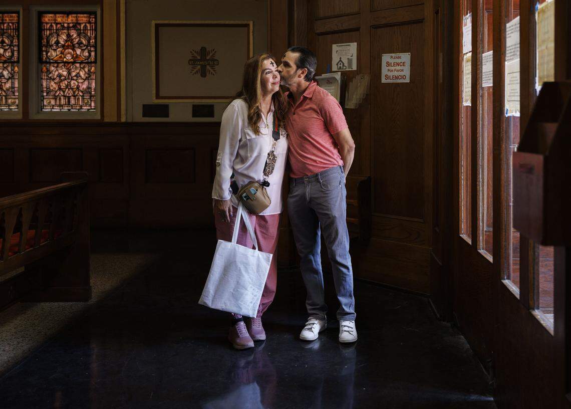 Jorge Ferragut, right, kisses Eileen Faxas on their way out of Ash Wednesday mass on Wednesday, Feb. 18, 2026, at Gesu Catholic Church in downtown Miami.  