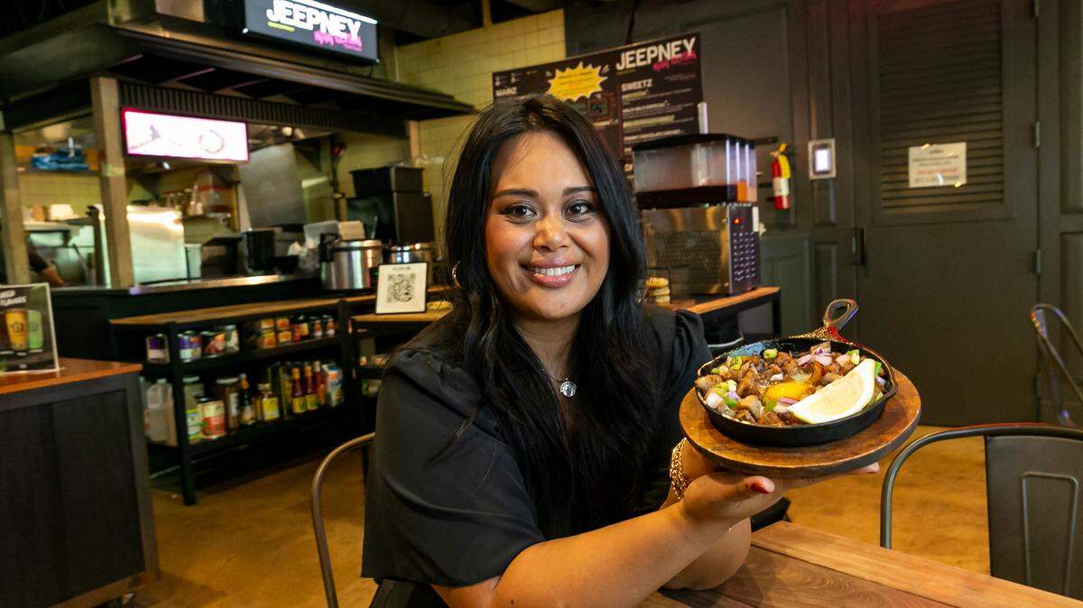 Nicole Ponseca with a plate of pork sisig at her Filipino restaurant Jeepney in Wynwood’s 1-800-Lucky food hall.