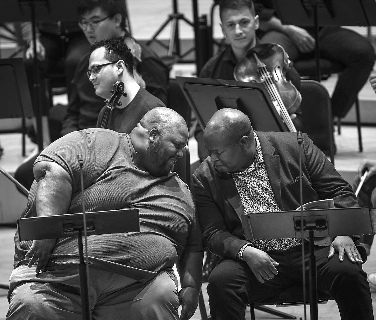 Limmie Pulliam, tenor, left, and with Muse Ngqungwana, bass-baritone, right, exchange insights during rehearsal with the New World Symphony under the direction of British conductor Douglas Boyd at the Arsht Center’s Knight Concert Hall on Saturday, January 13, 2024.