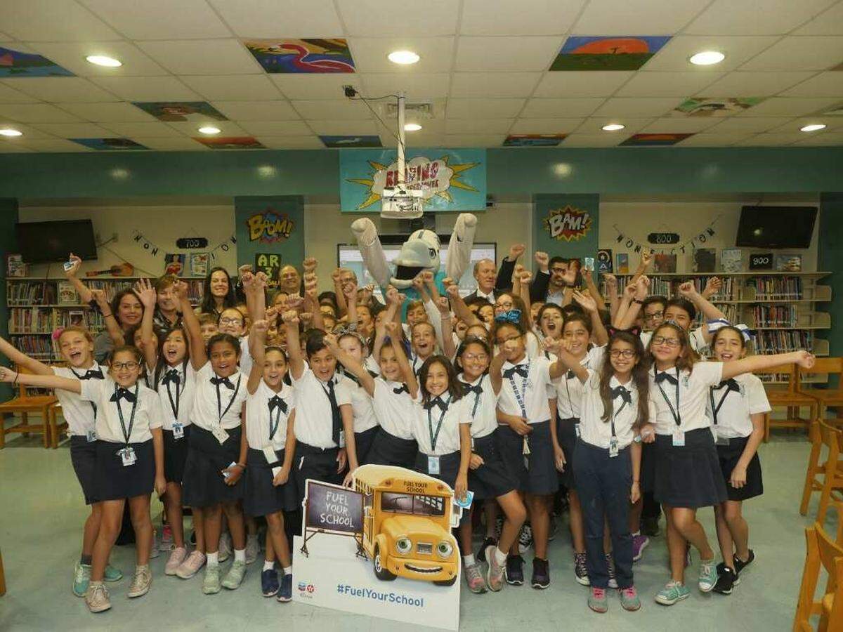 Elementary students from Eugenia B. Thomas K – 8 Center recently received seven laptops from Chevron team members as part of the Fuel Your School Program. The students are pictured with Doral Mayor Juan Carlos Bermudez; state Rep. Manny Diaz Jr.; George Wall, vice president of Americas Product at Chevron; Wendy Lopez, social investment coordinator at Chevron;  Max Alvarez, founder and president of Sunshine Gasoline Distributors; Principal Debbie Saumell; and instructors Techie Gúzman and Carolina Izquierdo.